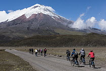 Bikers riding near volcano, Cotopaxi Volcano, Cotopaxi National Park, Andes, Ecuador