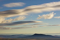 Lenticular clouds over tundra, Dempster Highway, Yukon, Canada