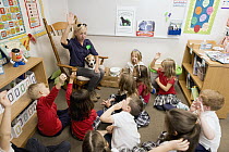 Conservation Canines field technician, Julianne Ubigau, teaching second grade students about their work, Washington