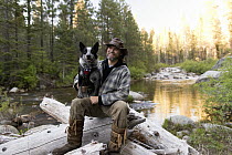 Domestic Dog (Canis familiaris) named Pips, a scent detection dog with Conservation Canines, and field technician Heath Smith, Sierra Nevada, California