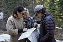 Conservation Canines field technicians consulting map, Washington