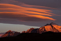 Clouds at sunrise over mountain range, Torres del Paine National Park, Patagonia, Chile