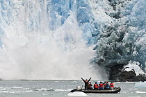 Tourists watching calving glacier, Alaska