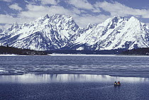 Tourists in canoe in winter, Jackson Lake, Grand Teton National Park, Wyoming