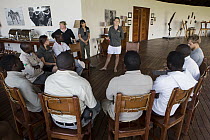 African Lion (Panthera leo) biologists, Caz Sanguinetti and Kim Young-Overton, giving presentation to tour guides, Kafue National Park, Zambia