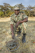 Park scout, Victor Samalumo, in anti-poaching patrol with confiscated snares, Kafue National Park, Zambia
