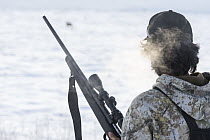 Caribou (Rangifer tarandus) Gwichin hunter, Clifton Salu, looking for caribou in winter, Yukon, Canada