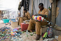 Artists working on sculptures made from reclaimed flip-flops, Ocean Sole, Nairobi, Kenya