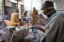 Artists working on sculptures made from reclaimed flip-flops, Ocean Sole, Nairobi, Kenya