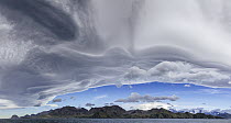 Lenticular cloud formations over coastline, Barff Point, Cumberland East Bay, South Georgia Island