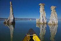 Canoe on lake with calcium tufa formations, Mono Lake, California