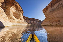 Canoe on lake with eroded sandstone cliffs, Antelope Canyon, Lake Powell, Glen Canyon National Recreation Area, Utah