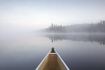 Canoe on lake on foggy morning, Grand Marais, Minnesota
