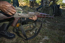 Anti-poaching scout checking rifle before deployment, Kafue National Park, Zambia