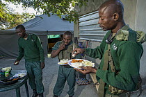 Anti-poaching scouts eating breakfast before deployment, Kafue National Park, Zambia