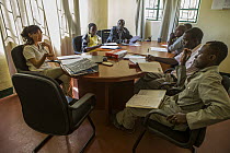 Cheetah (Acinonyx jubatus) conservationist, Kim Young-Overton, talking with commanders about anti-poaching strategies, Kafue National Park, Zambia