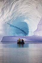 Tourists in zodiac near iceberg, Scoresby Sound, Greenland