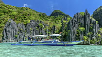 Tourists on boat in tropics, Cadlao Island, Philippines