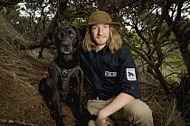 Domestic Dog (Canis familiaris) named Hooper, a scent detection dog with Conservation Canines, with field technician Will Chrisman, Oregon Dunes National Recreation Area, Oregon