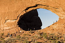 Tourists at arch, North Window Arch, Arches National Park, Utah