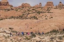 Large number of tourists on overcrowded hiking trail, Delicate Arch, Arches National Park, Utah