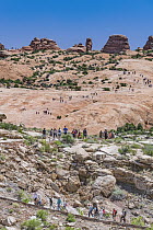 Large number of tourists on overcrowded hiking trail, Delicate Arch, Arches National Park, Utah