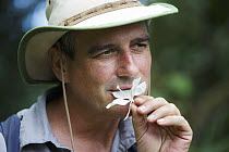 Botanist, Dr. Anton Weissenhofer, botanist eating flower in tropical rainforest, Golfito, Costa Rica