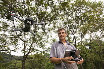 Botanist, Dr. Anton Weissenhofer, using drone to look at tropical rainforest regeneration, Golfito, Costa Rica