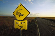 Saltwater Crocodile (Crocodylus porosus) road sign warning drivers of their possible presence, Northern Territory, Australia