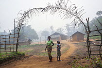 Woman and child at village entrance, Kokolopori Bonobo Reserve, Democratic Republic of the Congo