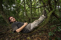 Photographer, Christian Ziegler, resting on liana, Kokolopori Bonobo Reserve, Democratic Republic of the Congo