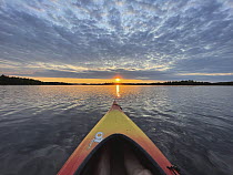 Kayak at sunrise on lake, Minnesota