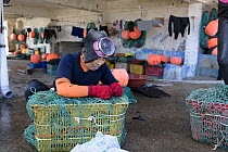 Haenyeo, a traditional fishing diver, tending gear, Jeju Island, South Korea