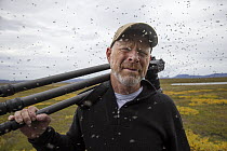 Photographer Ingo Arndt in a swarm of midges, Myvatn, Iceland