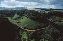 Silted river runs past forest preserved by the Serra Grande Sugar Company on more than one-third of its 60,000 acres in order to protect a watershed, Alagoa, south Brazil