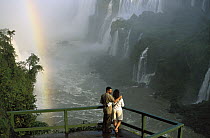 Tourists admiring the Iguacu Falls, world's largest waterfalls and the largest tourist attraction in the Atlantic Forest ecosystem, Brazil and Argentina border