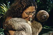 Maned Sloth (Bradypus torquatus) pair rescued from hunters, are held and soothed by Lucia de Oliveira at a rehabilitation center near Ilheus, Atlantic Forest, Brazil