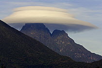 Mikeno Volcano (3634 meters) with lenticular cloud, Republic of the Congo in the Virunga heartland, view from Rwanda