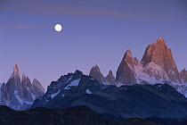 Moon over mountain range at sunrise, with Cerro Torre and Fitzroy, Los Glaciares National Park, Argentina
