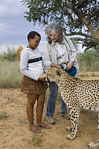 Cheetah (Acinonyx jubatus) named Chewbacca introduced by Dr. Laurie Marker to Namibian school child during an education program, Cheetah Conservation Fund, Namibia