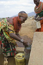 Samburu collecting fresh drinking water at Namunyak Wildlife Conservancy well built by Lewa Wildlife Conservancy, Kenya