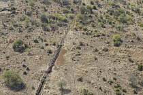 Electric fence at Lewa Wildlife Conservancy, where elephants and other animals can cross except rhinos, which will not go over the rocks, Kenya