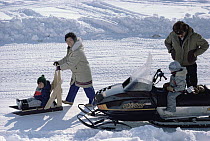 Modern Inuit family with snowmobiles, Ellesmere Island, Nunavut, Canada
