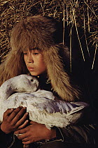 Domestic Goose held by child, China