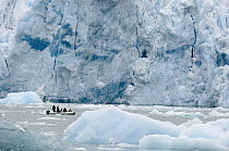 Tourists observing glacier and bergy bits from inflatable boat, southeast Alaska