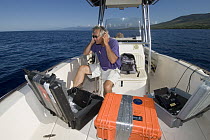 Marine biologist Dr. Jim Darling listening to and recording Humpback Whale (Megaptera novaeangliae) songs, Humpback Whale National Marine Sanctuary, Maui, Hawaii