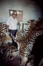 Mr. A.Kumar of Traffic India (conservation organisation) with tiger skins and bones confiscated from dealers, 1993.
