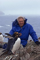David Attenborough with Macaroni penguin, South Georgia, 1992. On location for BBc Life in the Freezer