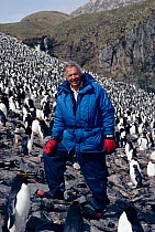 David Attenborough in Macaroni penguin colony. South Georgia 1992. On location for BBC tv series 'Life in the Freezer'