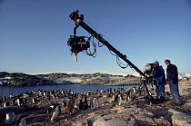 Producer Peter Basset with cameraman Paul Atkins using gibarm to film Adelie penguins for BBC series Life in the Freezer 1992